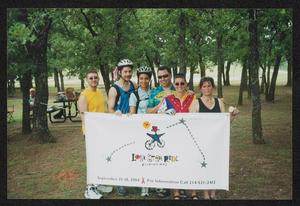 [Six riders posing behind a LSR banner: Lone Star Ride 2004 event photo]