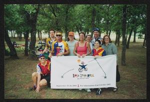 [Nine individuals posed behind a LSR banner: Lone Star Ride 2004 event photo]