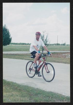 [Cyclist riding along a flat road: Lone Star Ride 2004 event photo]