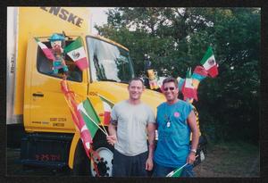 [Two volunteers posed by a decorated Penske truck: Lone Star Ride 2004 event photo]