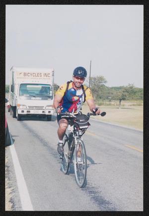 [Cyclist riding in front of a truck: Lone Star Ride 2004 event photo]