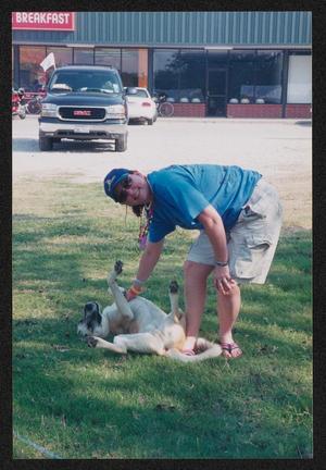 [Volunteer petting a dog: Lone Star Ride 2004 event photo]