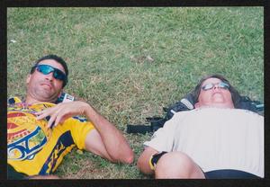 [Two individuals laying on the grass: Lone Star Ride 2004 event photos]
