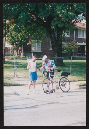 [A cyclist stopped to talk to another man: Lone Star Ride 2004 event photo]