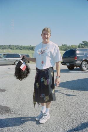 Primary view of object titled '[Volunteer holding a black wig: Lone Star Ride 2001 event photo]'.