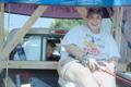 Thumbnail image of item number 1 in: '[Woman smiling as she sits in the bed of a truck: Lone Star Ride 2001 event photo]'.