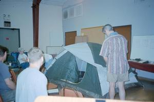 [Man giving a tutorial on how to pitch a tent: Lone Star Ride 2001 event photo]