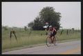 Primary view of [Cyclist #220 riding down a rural road: Lone Star Ride event photo]