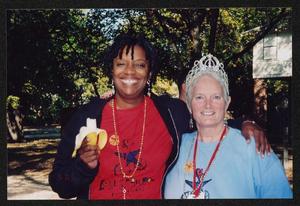 Primary view of object titled '[Janie Bush and a woman eating a banana: Lone Star Ride 2005 event photo]'.