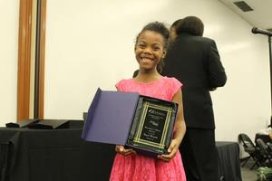 Primary view of object titled '[Niyah Murphy receives award at Congo Street ceremony]'.