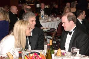 [Sharon Stone converses with men at 2005 Black Tie Dinner]