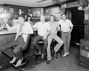 [Photograph of men at a bar]