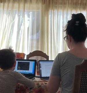 [Kristen King and child using laptops]