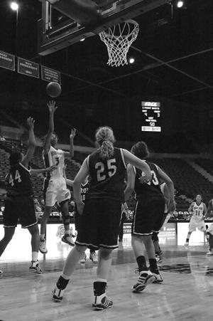 Primary view of object titled '[Amber Jackson attempts to shoot ball during Troy game]'.
