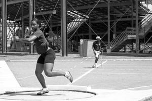 Primary view of object titled '[Alana Tyler competes in shot put event, 1]'.