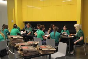 [Students eating pizza, College of Music at the Perot Museum]