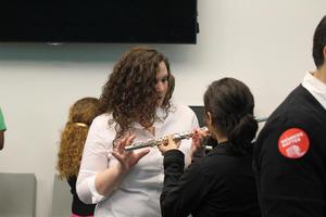 [Teacher instructing person how to play the flute, College of Music at the Perot Museum]