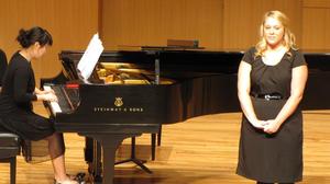 [Singer performing with piano at the Student recital during Jake Heggie's residency, 1]
