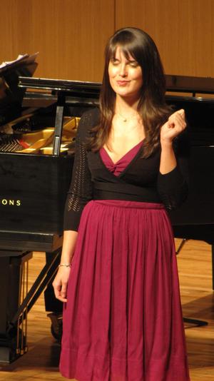 [Close-up of singer wearing a pink dress performing at the Student recital during Jake Heggie's residency, 1]