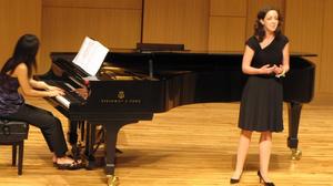 [Singer wearing black dress performing at the Student recital during Jake Heggie's residency, 2]