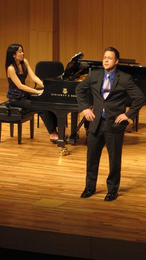 [Singer wearing purple tie performing at the Student recital during Jake Heggie's residency, 1]