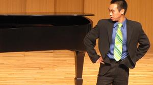 [Singer with green tie performing at the Student recital during Jake Heggie's residency, 1]