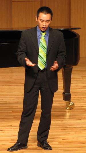 [Singer with green tie performing at the Student recital during Jake Heggie's residency, 2]