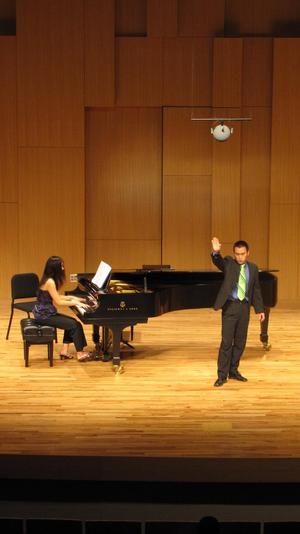 [Singer with green tie performing at the Student recital during Jake Heggie's residency, 6]