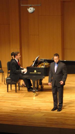 [Singer wearing purple tie performing at the Student recital during Jake Heggie's residency, 8]