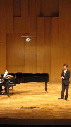 [Close-up of singer wearing a yellow tie at the Student recital during Jake Heggie's residency, 8]