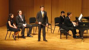 [Singer wearing a yellow tie and performing with Heggie at the Student recital during Jake Heggie's residency, 1]
