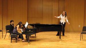 [Singer wearing a white shirt performing at the Student recital during Jake Heggie's residency, 6]