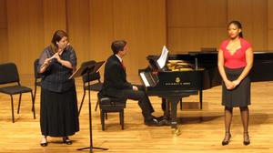 [Singer, flute player, and Heggie playing piano at the Student recital during Jake Heggie's residency]