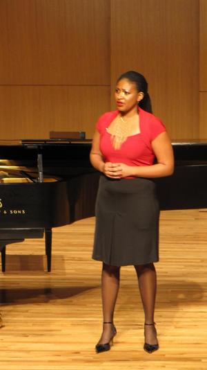 [Singer wearing a red blouse performing at the Student recital during Jake Heggie's residency, 5]