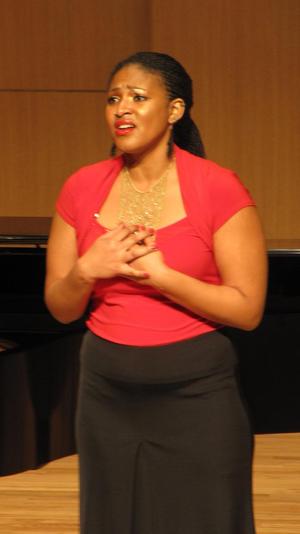 [Singer wearing a red blouse performing at the Student recital during Jake Heggie's residency, 2]
