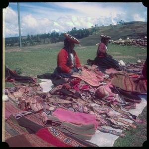 [Two Women Selling Clothing at a Market]
