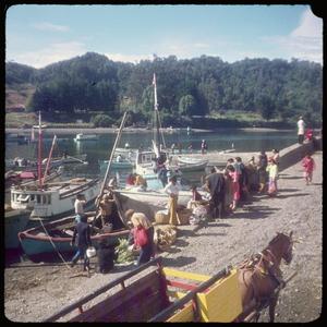 [People standing next to boats in Puerto Montt and Angelmó]