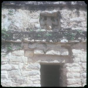 [A carved figure above a temple entrance]