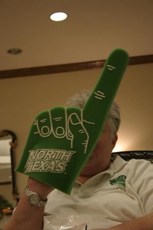 [Woman holds foam finger at Aerie Yearbook staff party, 3]