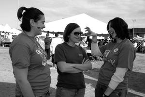 [Shelley Saltzman, Rebekah Wolf, and Bonny Smith converse at outdoor event]