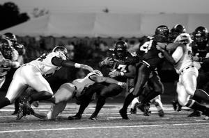 Primary view of object titled '[Troy players tackle Patrick Cobbs]'.
