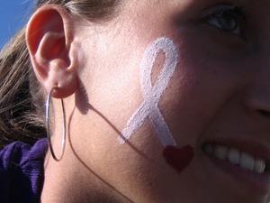 [Zeta Tau Alpha member wears breast cancer awareness face paint]