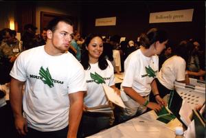 [Student volunteers pass out items at UNT rebrand unveiling]