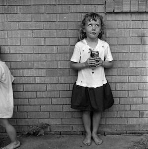 [Two children standing in front of a brick wall #11]