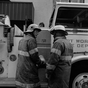 [Two firefighters talking to each other]