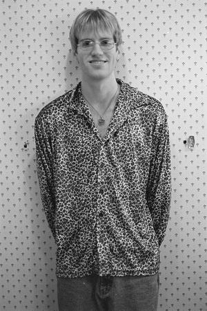 [Dustin Hall in front of a patterned wall, 2]