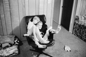 [Derrick Williams and a boy sharing a chair #2]