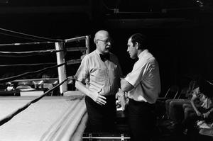 [Two men next to a boxing ring #3]