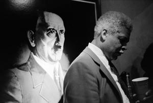 [A man and a painting of Hitler]