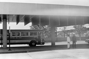 Primary view of object titled '[A parked bus and two men #1]'.